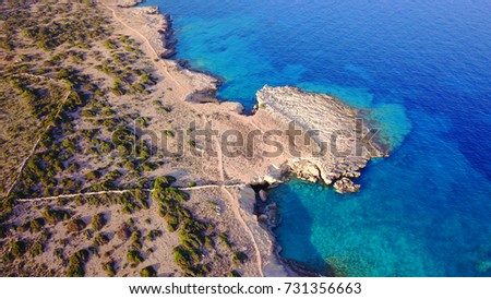 Aerial drone top view photo of beautiful caves and rocky seascape near Pori beach with deep blue - turquoise sea, Koufonisi island, Cyclades, Greece
