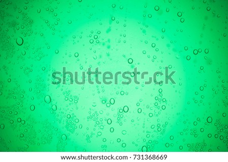 Rain droplets on green glass background, Water drops on glass.