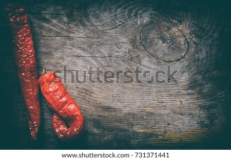 Pod of red chili pepper on vintage wood background from above copy space