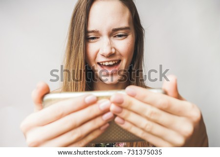 young girl playing games in mobile phone, addicted,selfie 
