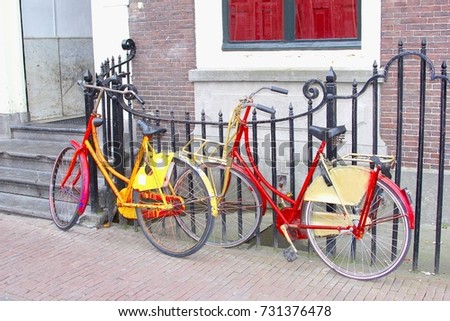 Two colorful retro bikes in front of typical old Dutch houses with steps and stairs, Leiden, Netherlands