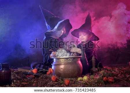 two halloween witches cooking a potion, lots of smoke