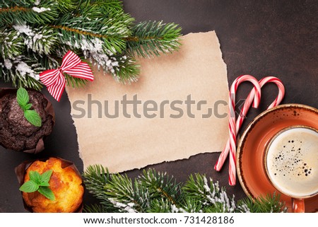 Piece of paper for christmas wishes, coffee cup, muffins and snow xmas tree. Top view with space for your text