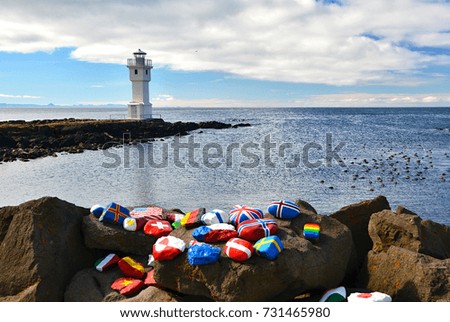 Iceland. Stone with flags and symbols in front of a picture. Typical scenery. 