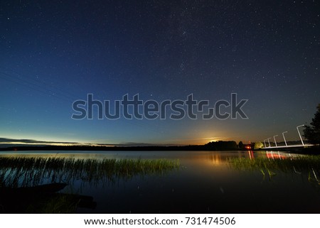 The stars in the night sky over the river.