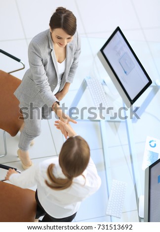 view from the top.business woman shaking hands with employee