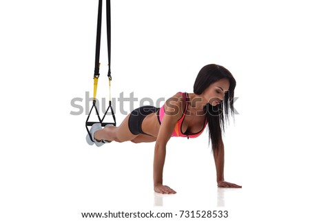 Woman exercising with suspension straps isolated on white background.