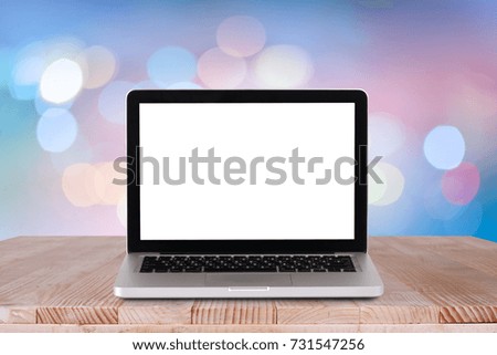 Front view of the laptop is on the work table with bokeh blue background 