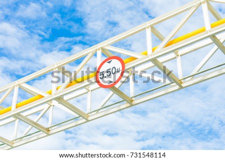 Height Restriction limit Sign on pipe rack, white metal sign on steel structure with blue sky