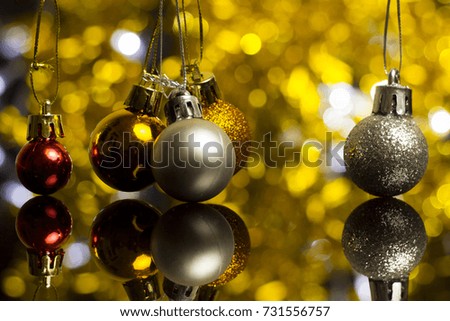 Christmas decoration on a golden background. bokeh background and dark mirror floor.