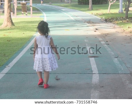 
Asian childs walking in lonely park alone.soft picture.
