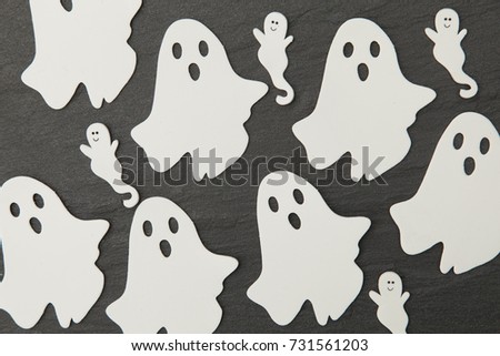 Halloween ghost shapes on a slate background