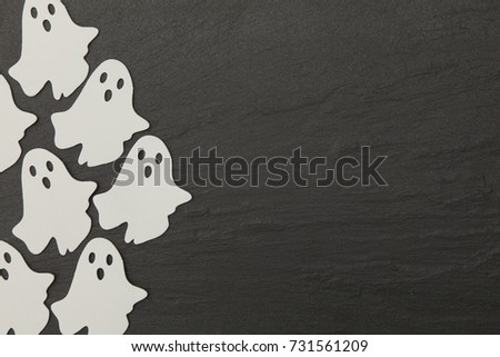 Halloween ghost shapes on a slate background