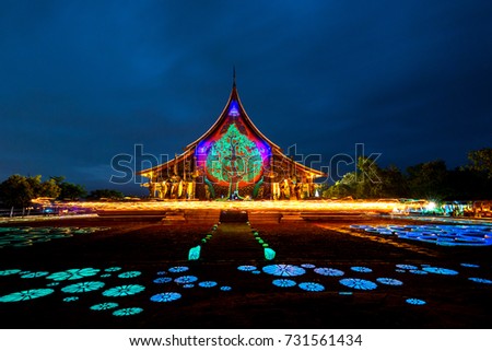 Amazing Temple Sirindhorn Wararam Phuproud in Ubon Ratchathani Province at twilight time Thailand.Colorful Thai temple with grain and select white balance.Night sky effect for Long exposure photo.