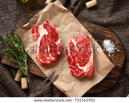 Raw fresh Chuck roll steak with herbs and salt on a cutting Board top view Royalty-Free Stock Photo #731561902