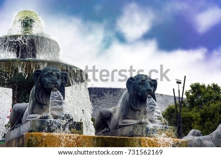 Fontaine aux lions (lion fountain) detail with blurred background.La Villette, Paris, France