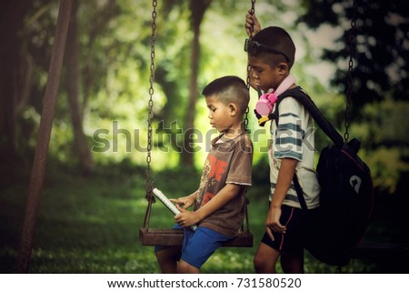 Asian boy reading book in the park outdoor countryside