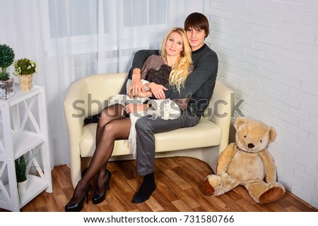 Attractive young couple sitting in their new home