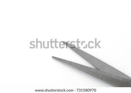 Black scissors over white background