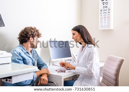 A Doctor writing a prescription in the Consultation room   