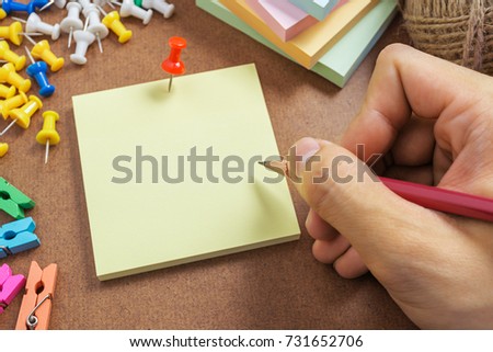 Close up picture of writing message on post note paper with right hand side