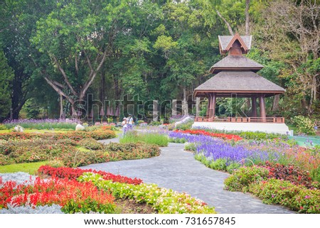 Colorful landscape view of flower garden and northern Thai's style wooden pavilion at Bhubing palace, Chiang Mai, Thailand. Royalty-Free Stock Photo #731657845