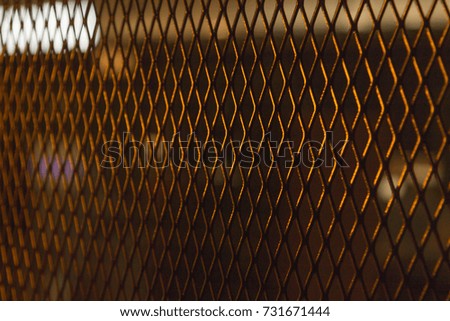 Metal grid with rhombus cell close-up as background or texture with blurred edges