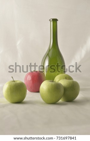 Apples and green bottle