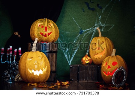 Five Halloween pumpkins, merry faces on a blue background.