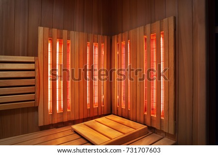 Interior of Finnish sauna, infrared panels for medical procedures, classic wooden sauna Royalty-Free Stock Photo #731707603