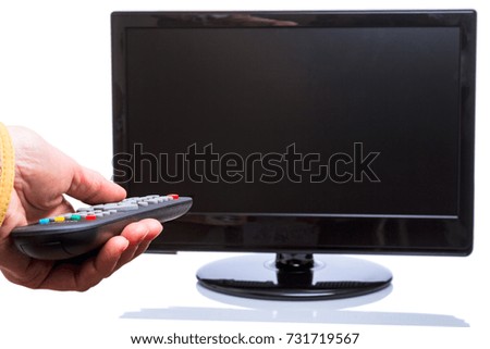 Hand with remote control and TV isolated on white background