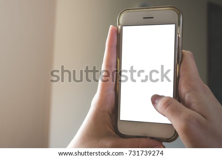 A woman holding a smart phone and using it. Close up hands and smart phone. Mock up.