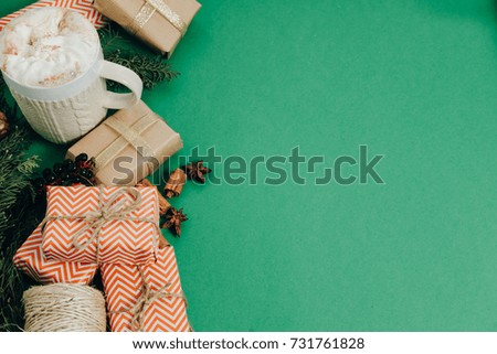 Decorated gift box on Green table cocoa flat lay, top view
