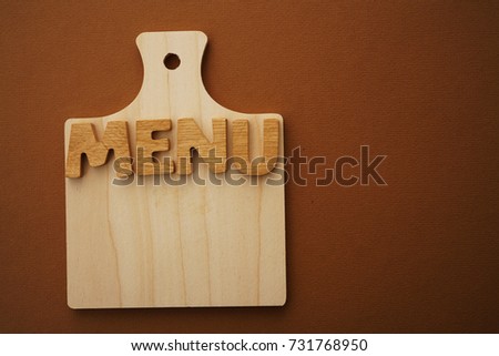 wood board with wooden letters - word menu. Empty copy space for inscription.