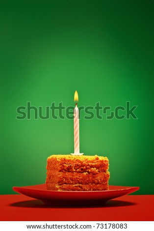 birthday cake with candle on pink background