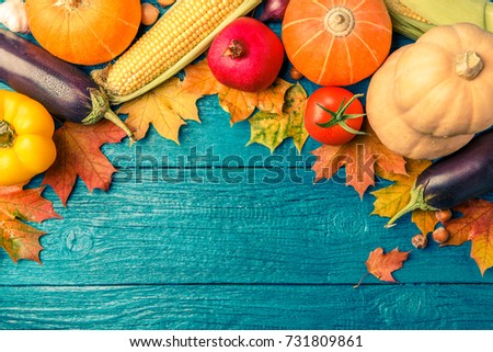 Image of blue wooden table with autumn vegetables, with place for inscription
