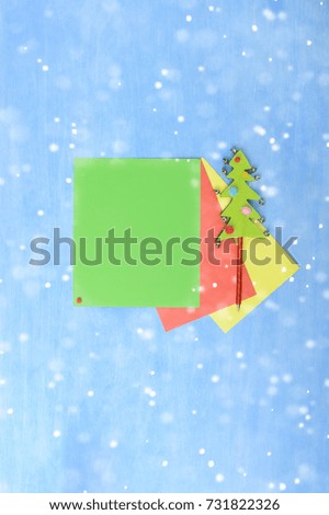 Colored paper with place for message and Christmas tree pen Holiday abstract background and falling snowflakes