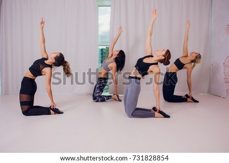 woman teaches yoga girls in the studio