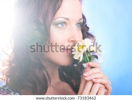 beautiful woman with flower on blue background