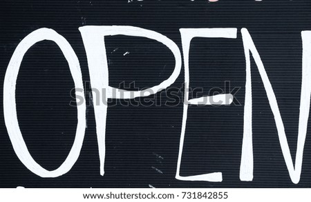 Symbolize open on wood background