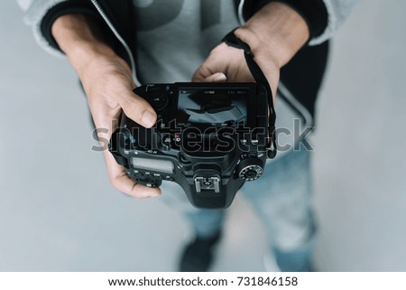 professional photographer adjusts the camera before shooting