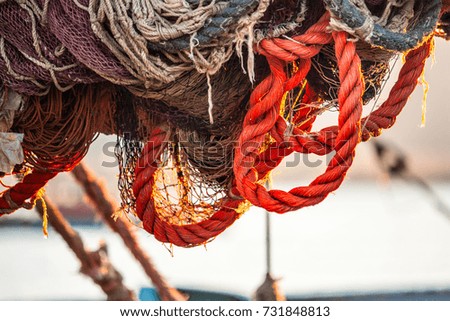 Drying fishing nets on the trawler in city harbor at sunset of the day