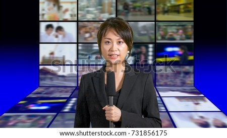 Asian American female news anchor in studio with screens in background