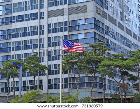 The American flag flapping in the city/American flag