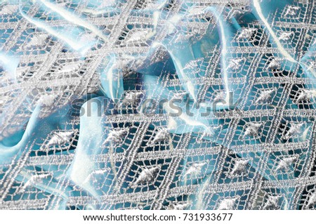 Texture background pattern. Lacy white fabric. Hand lace on white background. White guipure, embroidery on fabric for a wedding dress, postcard, photo wallpapers, poster,
