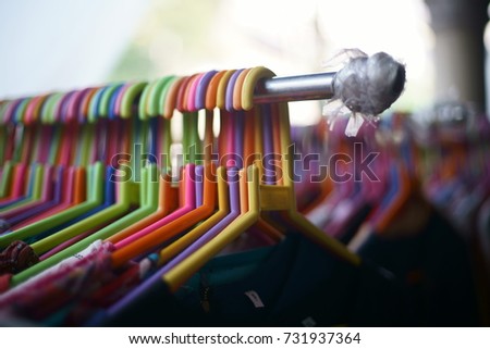 A closeup macro photograph of some clothes hanging, being sold at a road side shop in Mumbai, India.
