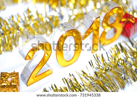Golden 2018 3d digital icon with gift box in the christmas ornaments golden tinsel defocused blur backgrounds