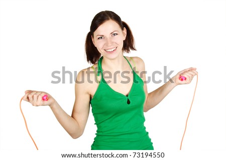 young girl in green shirt with skipping rope, smiling and looking at camera, isolated