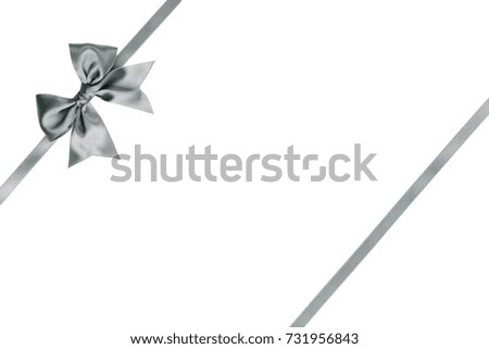 Beautiful silver ribbon bow with tails with parallel ribbon on white background