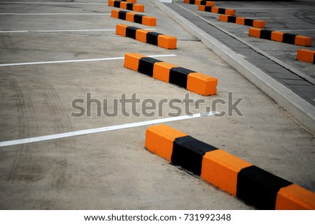 Wheel stop concrete with paint yellow and black of outdoor parking,